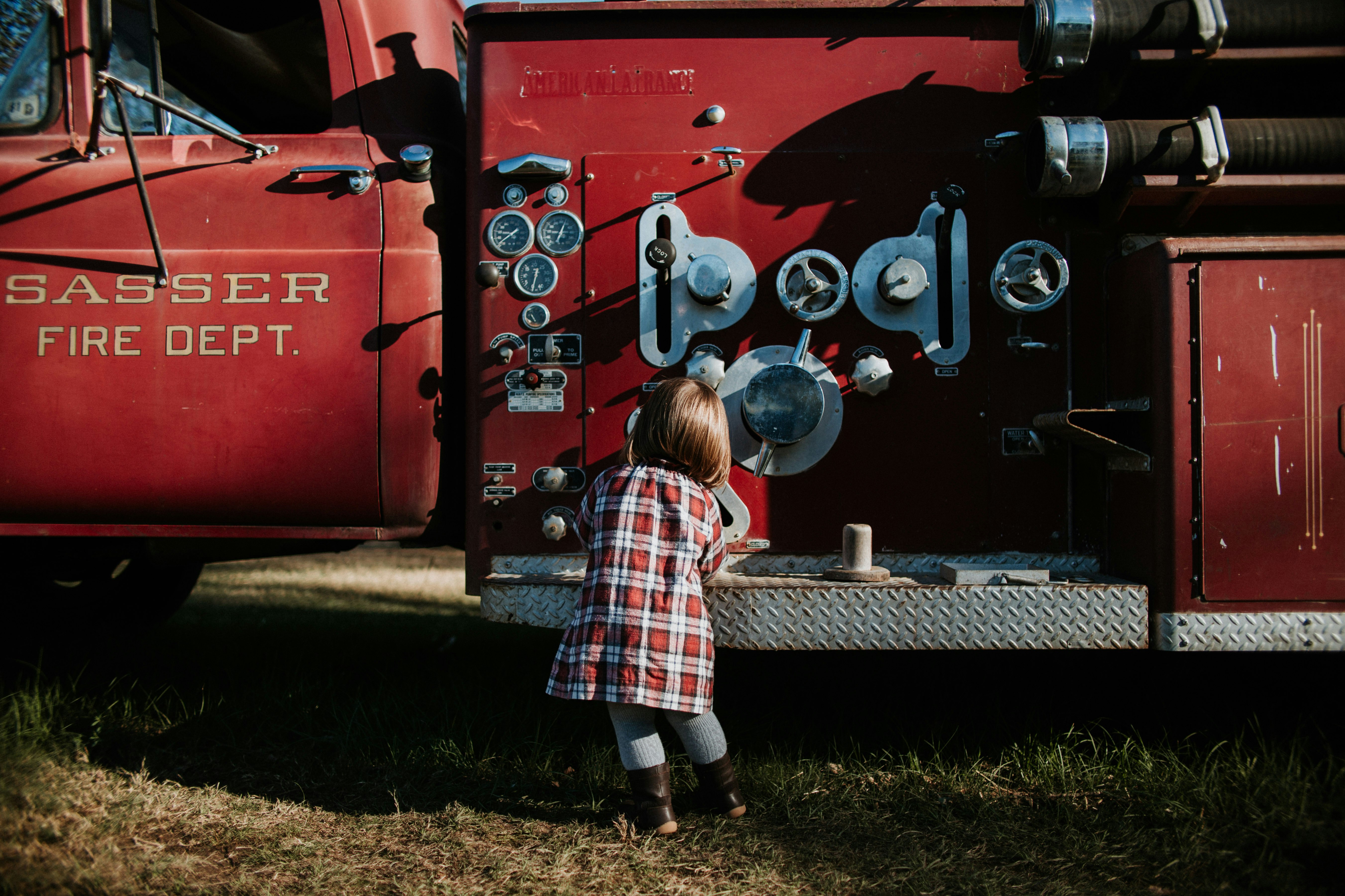 children ewaring sport shirt in front of vehicle